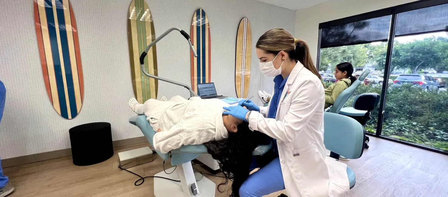 Dr. Brothers helping patient